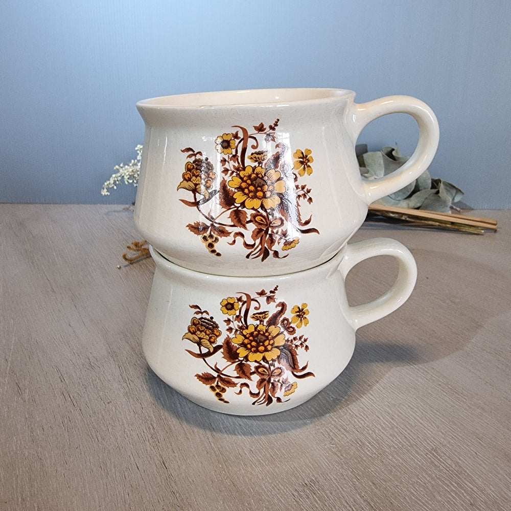 Pair of Crown Lynn soup mugs with golden floral design on cream glaze.