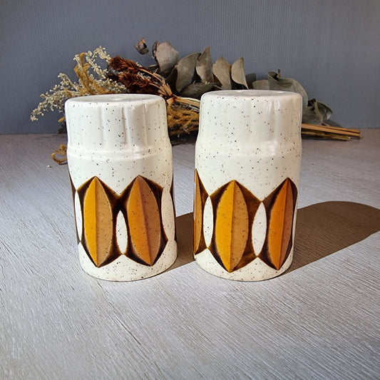 Pair of Palissy salt and pepper shakers with mustard and brown geometric design.