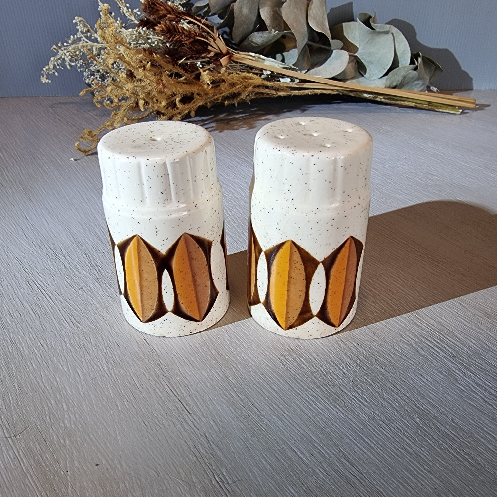 Pair of Palissy salt and pepper shakers with mustard and brown geometric design.