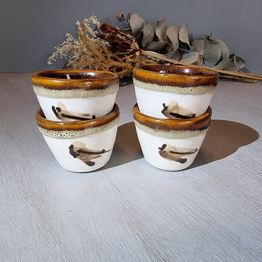 Set of 4 vintage handmade pottery cups with bird motif and brown glaze.