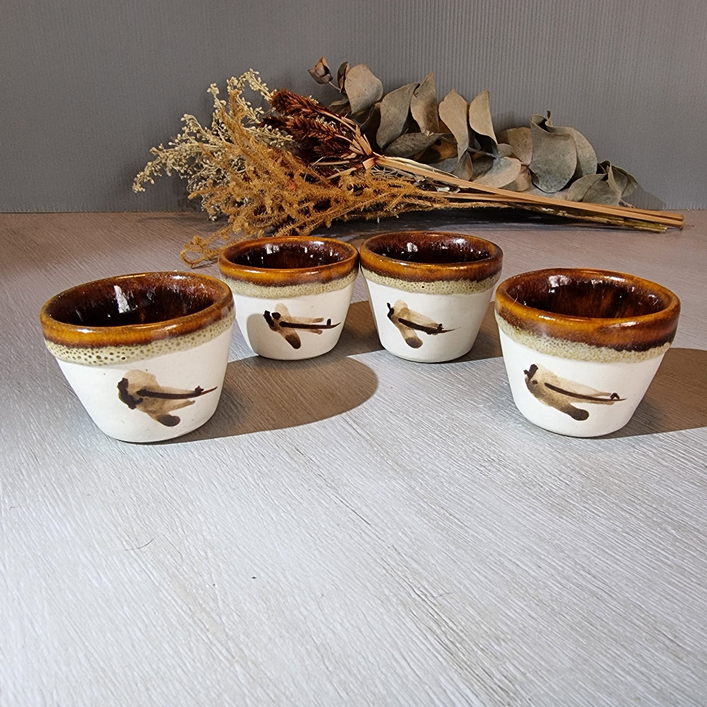 Set of 4 vintage handmade pottery cups with bird motif and brown glaze.
