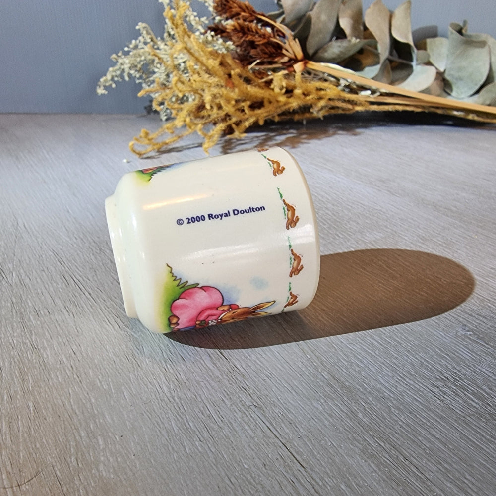 Royal Doulton Bunnykins egg cup with rabbit countryside scene.