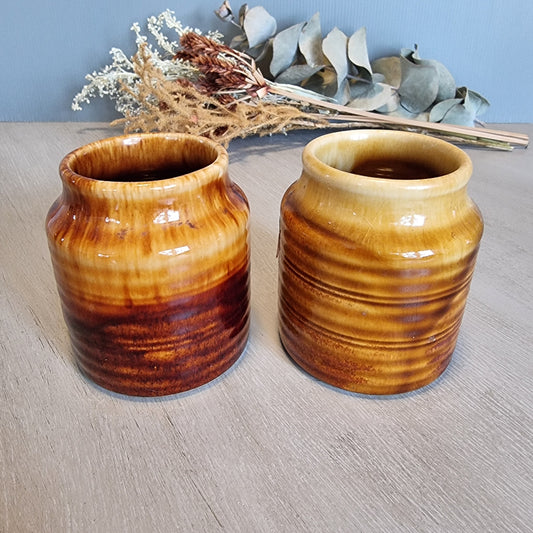 Pair of Crown Lynn drip glaze jars in golden brown tones.