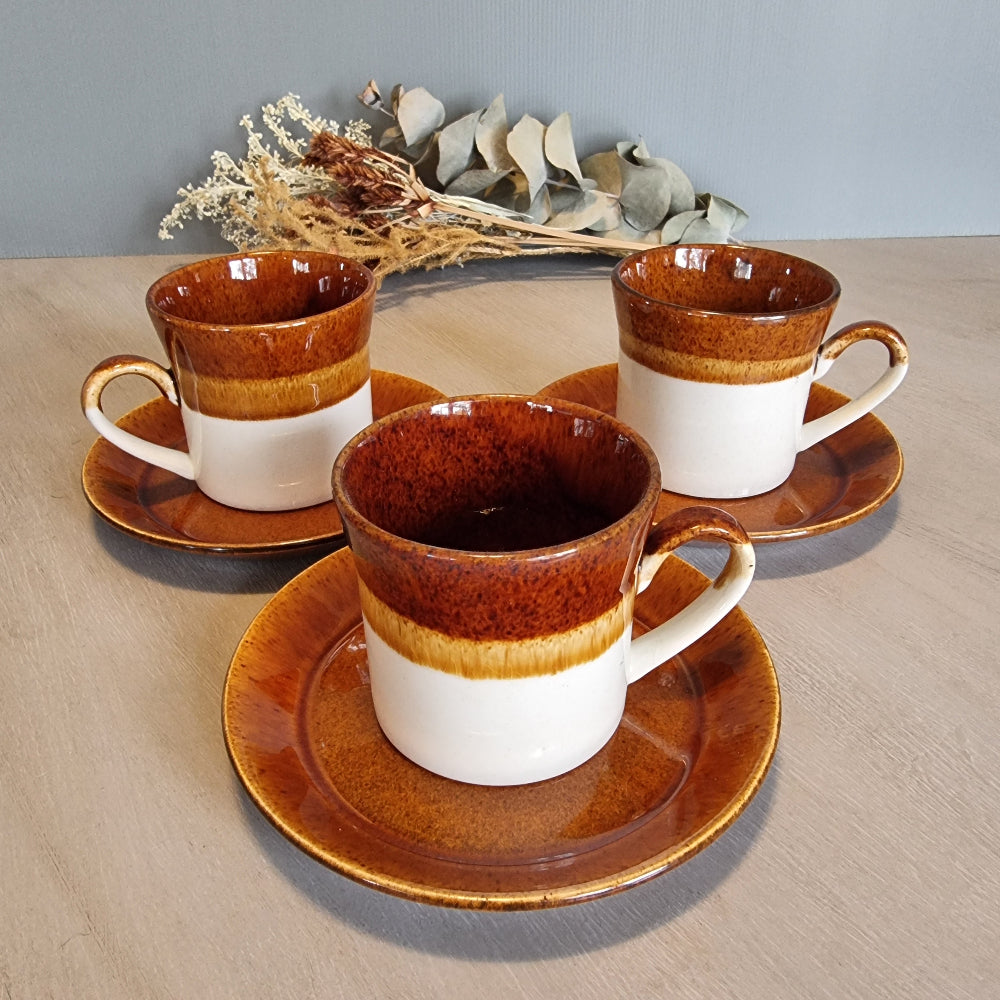 Crown Lynn Pioneer cups and saucers in brown and cream glaze, set of three.