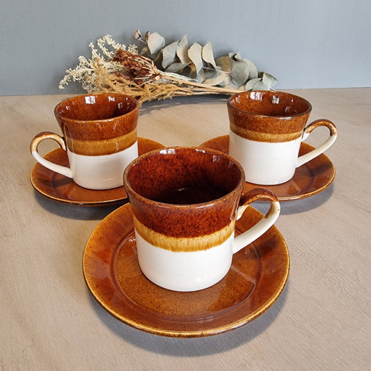 Crown Lynn Pioneer cups and saucers in brown and cream glaze, set of three.