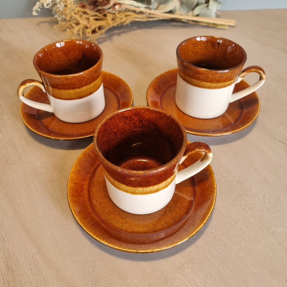 Crown Lynn Pioneer cups and saucers in brown and cream glaze, set of three.