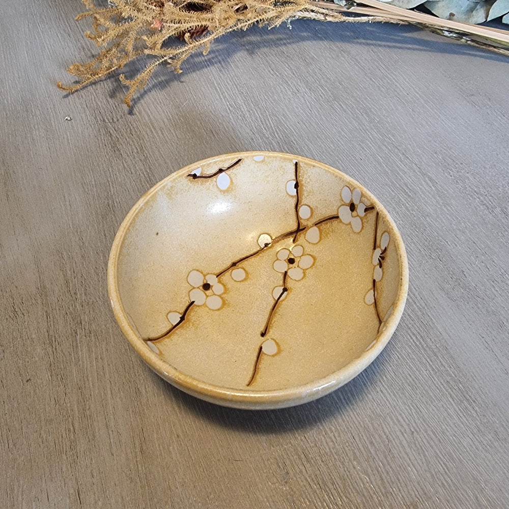 Japanese Kotobuki ceramic bowl with white blossom and branch design.