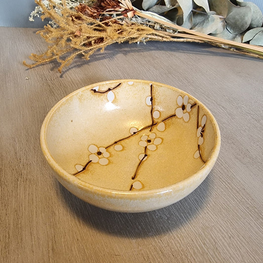 Japanese Kotobuki ceramic bowl with white blossom and branch design.