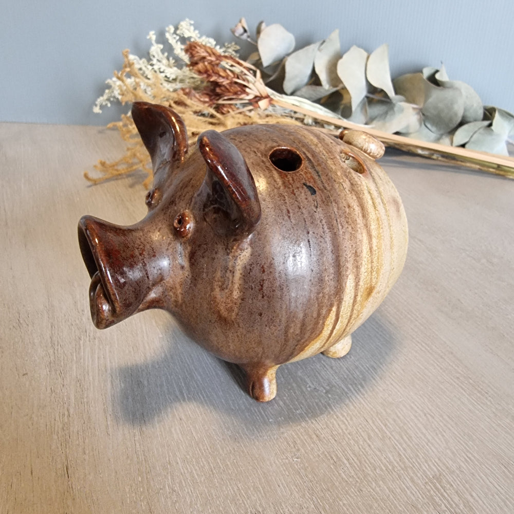 Vintage brown ceramic pig figurine with glossy glaze and open holes across the top