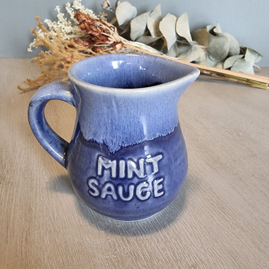 Vintage purple ceramic jug with “Mint Sauce” lettering, retro kitchen collectible.