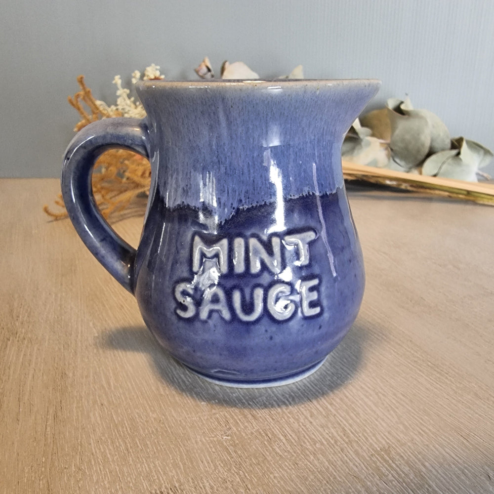 Vintage purple ceramic jug with “Mint Sauce” lettering, retro kitchen collectible.