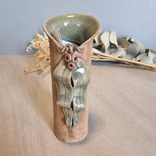 Sharon Twining handcrafted ceramic vase with gumleaf and gumnut design, earthy Australian pottery.