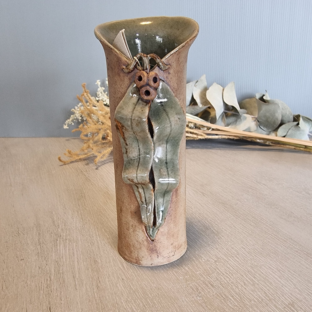 Sharon Twining handcrafted ceramic vase with gumleaf and gumnut design, earthy Australian pottery.