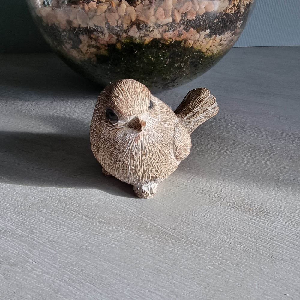 Rustic ceramic bird ornament with natural wood-tone finish.