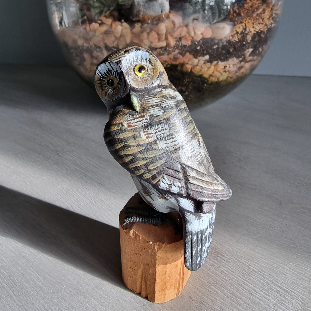 Hand-carved wooden owl ornament with painted feather details.