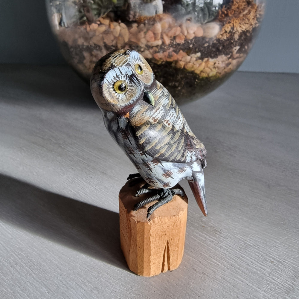 Hand-carved wooden owl ornament with painted feather details.