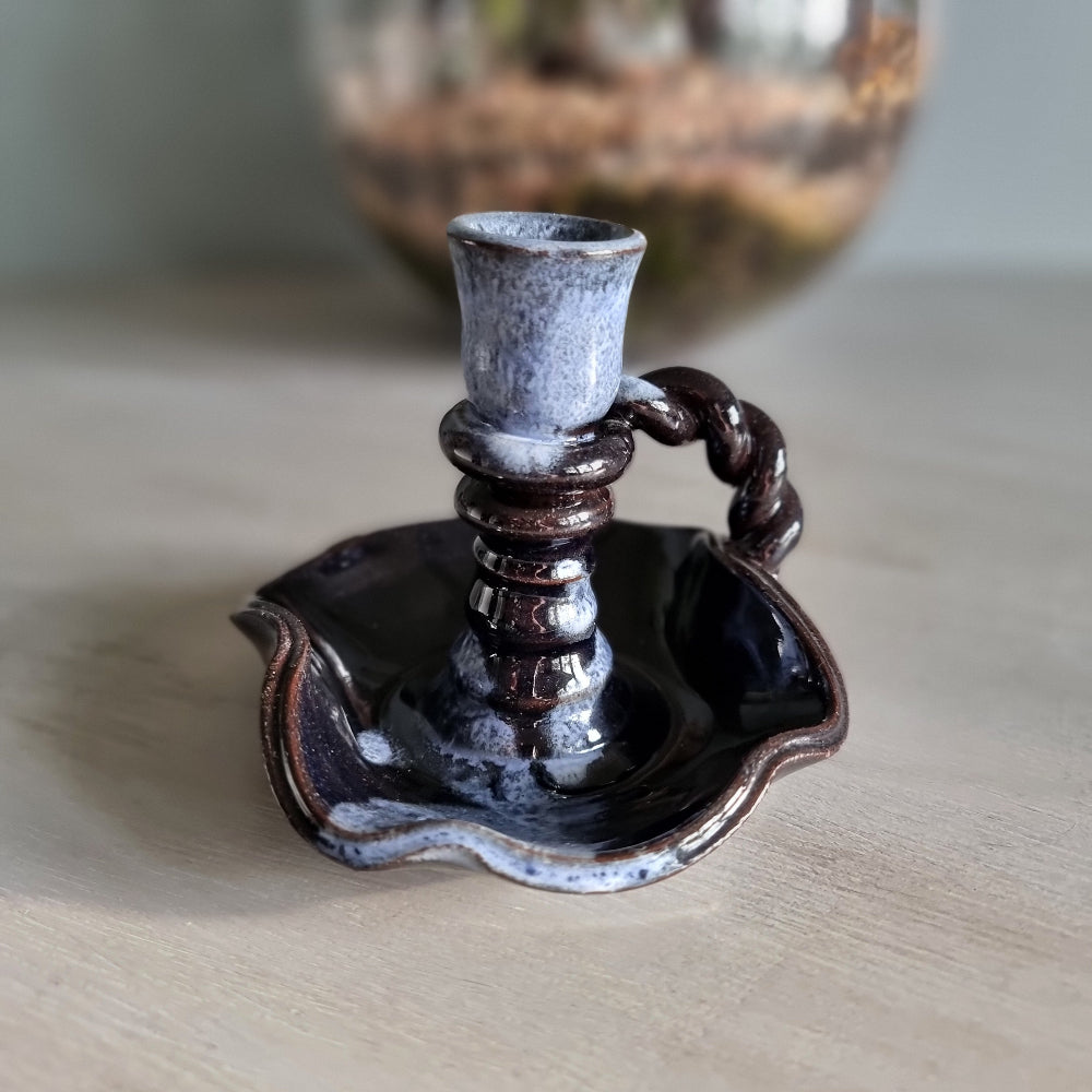 Vintage ceramic candlestick with brown-blue glaze and twisted handle.