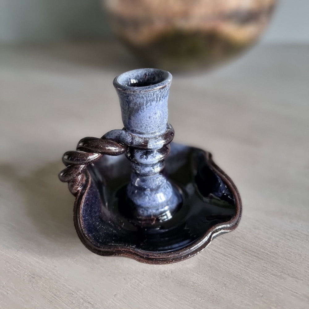 Vintage ceramic candlestick with brown-blue glaze and twisted handle.