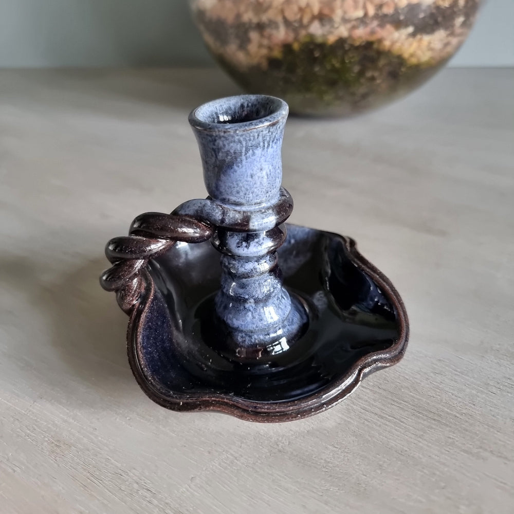 Vintage ceramic candlestick with brown-blue glaze and twisted handle.