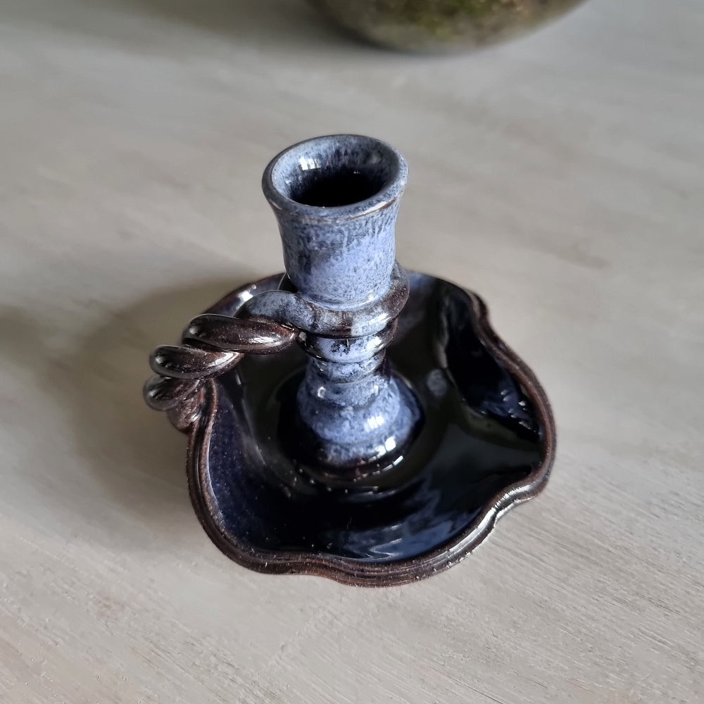 Vintage ceramic candlestick with brown-blue glaze and twisted handle.