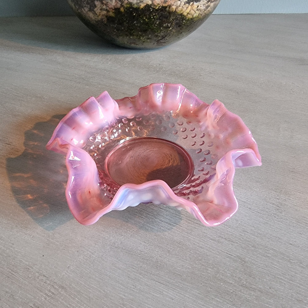 Vintage Fenton pink opalescent hobnail glass bowl with ruffled edge.