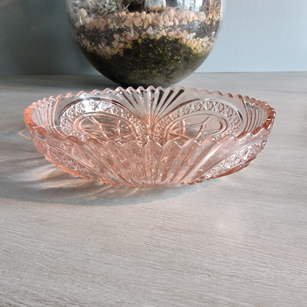 Vintage pink Depression glass bowl with scalloped edge and pressed pattern.