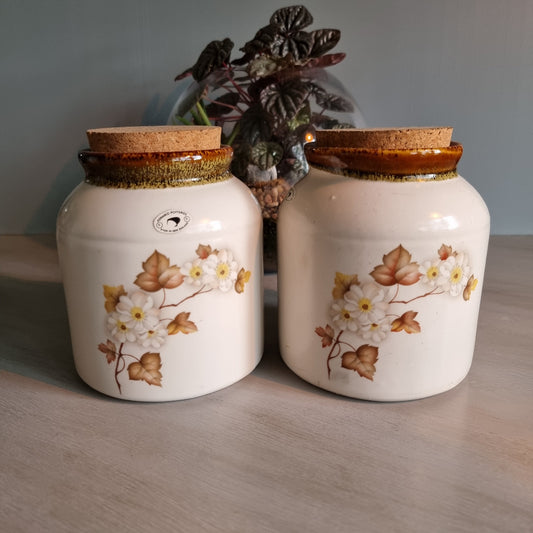 Pair of Kermiko Potteries floral ceramic jars with cork lids.
