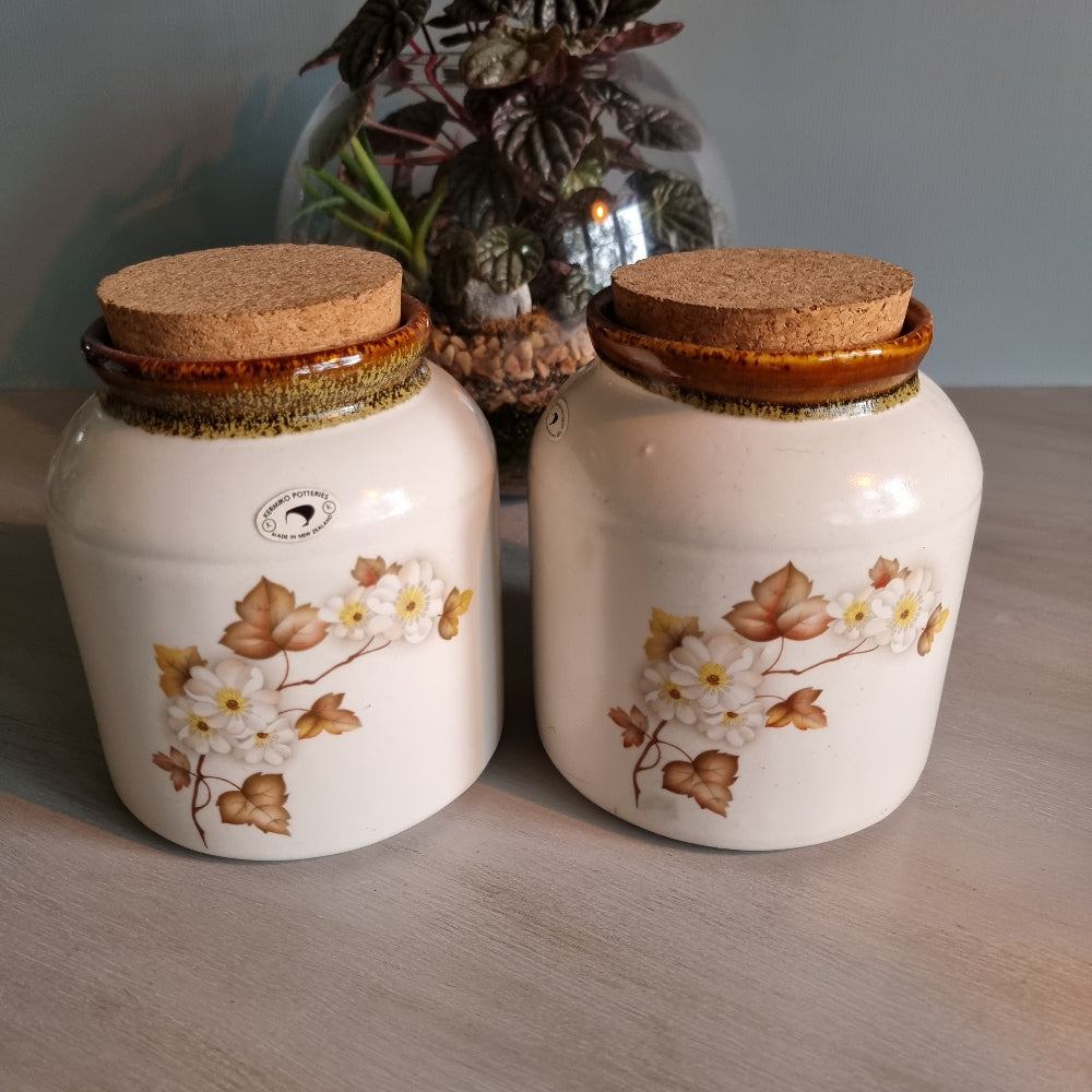 Pair of Kermiko Potteries floral ceramic jars with cork lids.