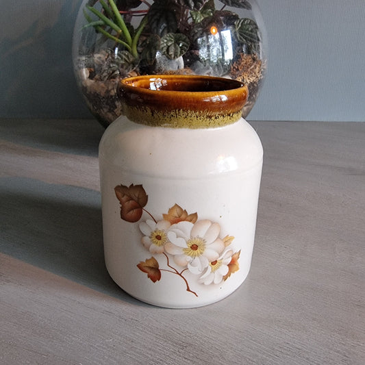 Kermiko Potteries floral ceramic jar with brown rim and blossom design.