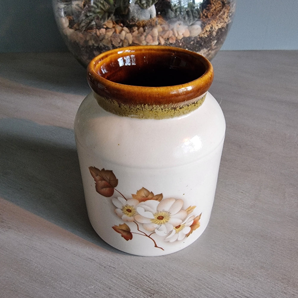 Kermiko Potteries floral ceramic jar with brown rim and blossom design.