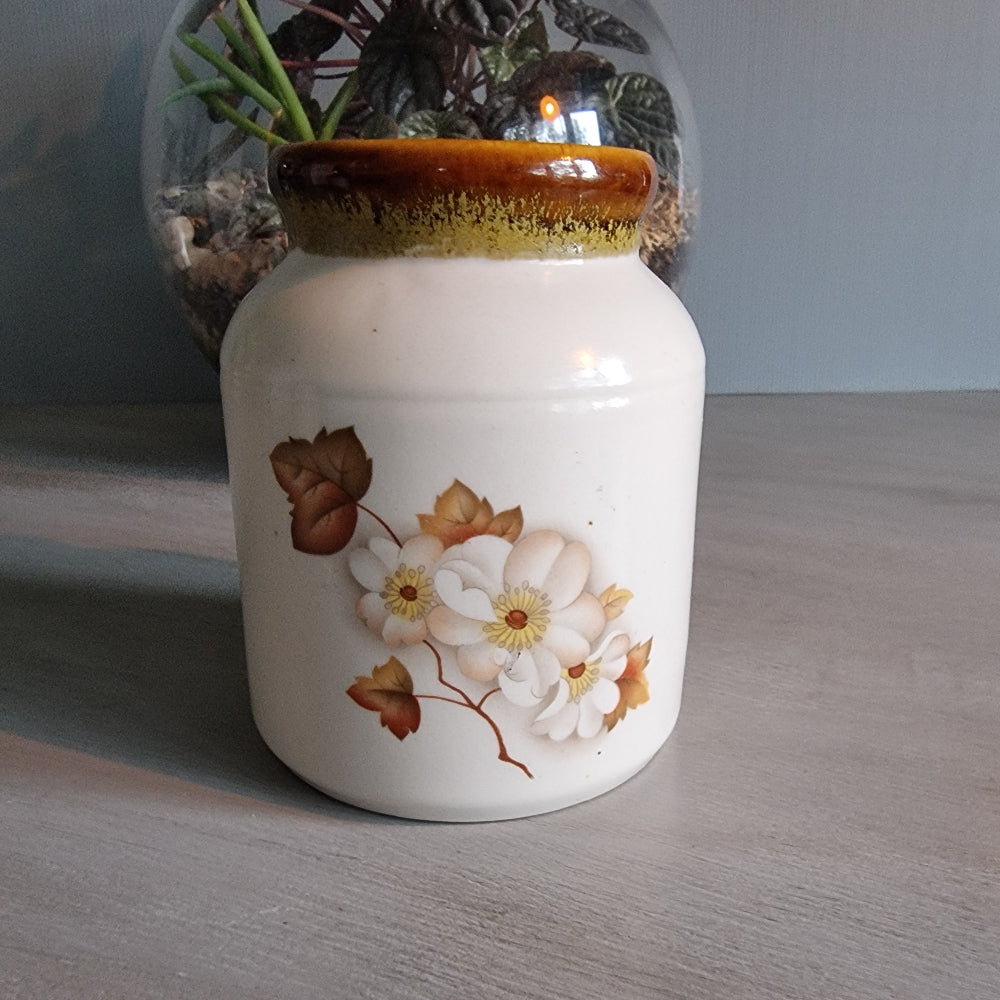 Kermiko Potteries floral ceramic jar with brown rim and blossom design.