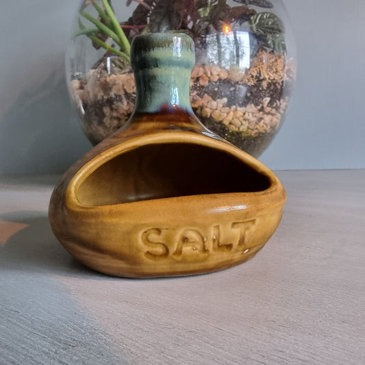 Vintage ceramic salt pig with mustard and green glaze.