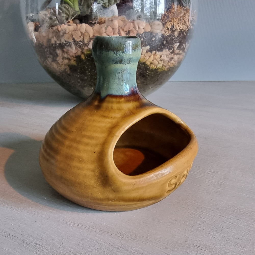 Vintage ceramic salt pig with mustard and green glaze.