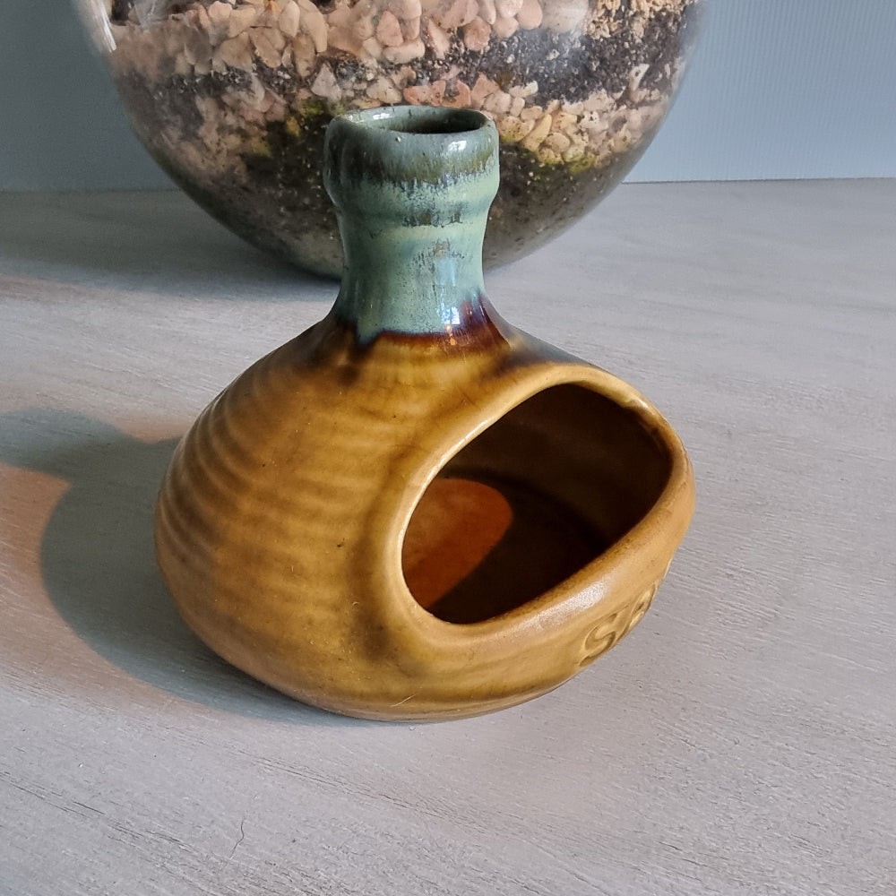 Vintage ceramic salt pig with mustard and green glaze.