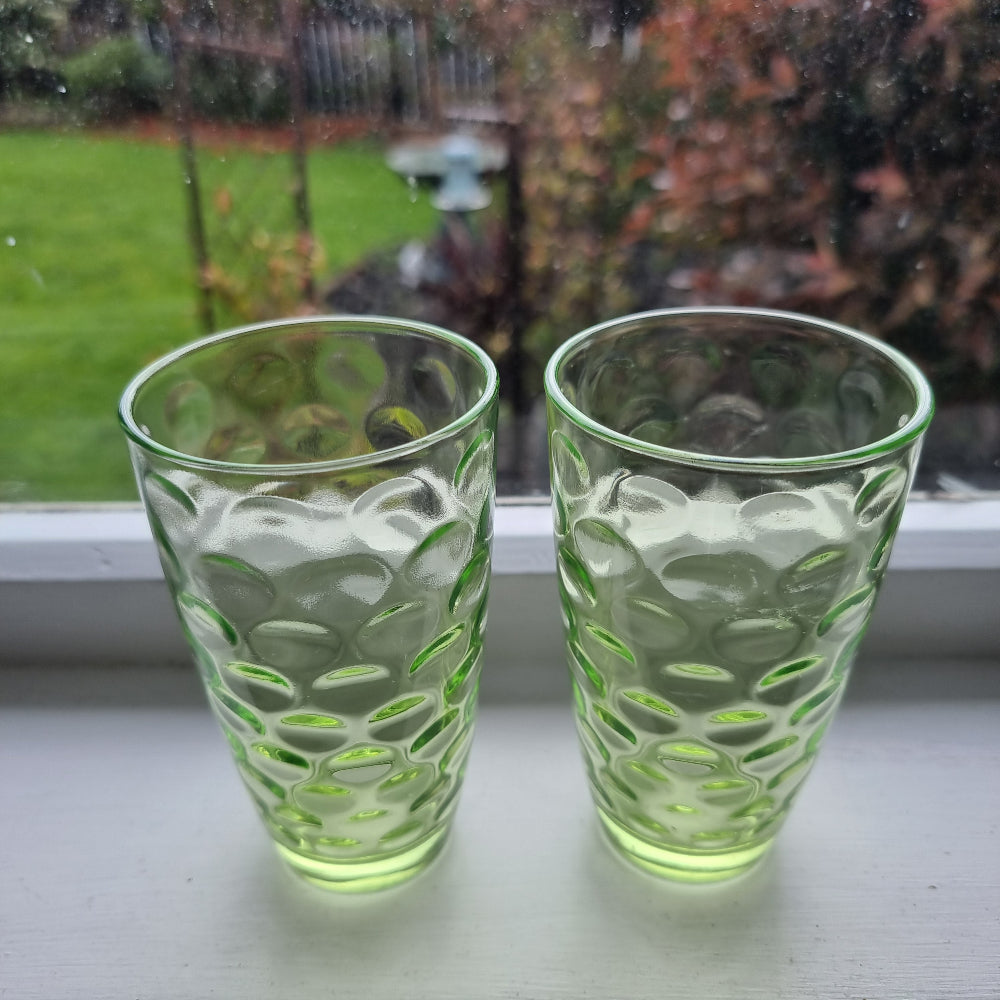 Pair of vintage green optic glass tumblers with bubble design and soft uranium glow.