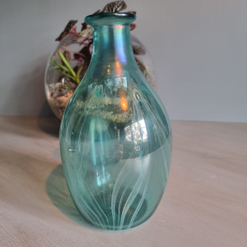 Hand-blown teal art glass vase with iridescent finish and feather swirl design.