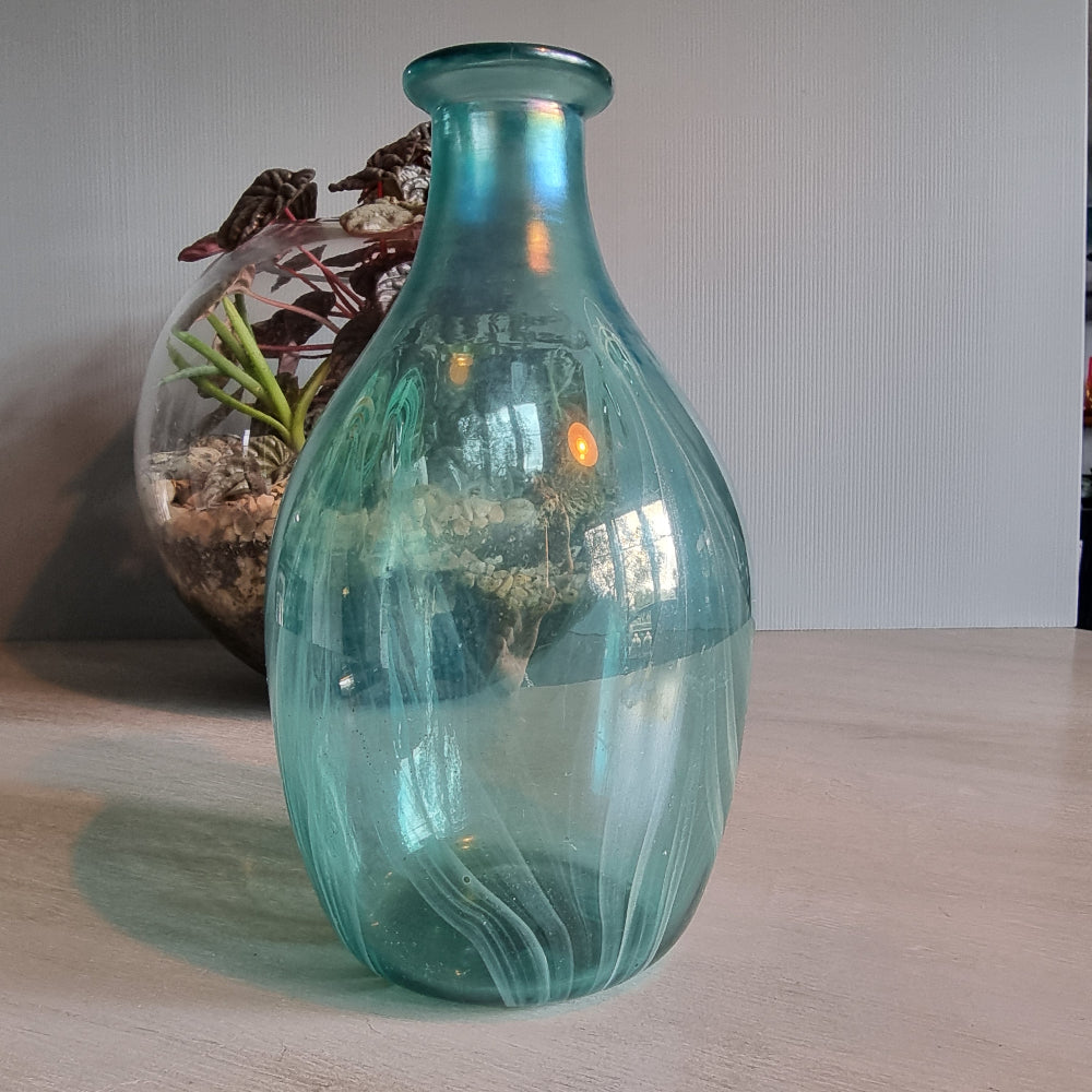 Hand-blown teal art glass vase with iridescent finish and feather swirl design.