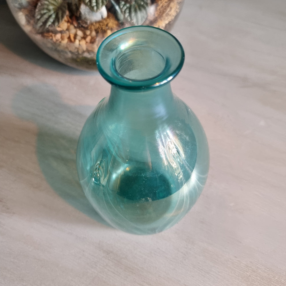 Hand-blown teal art glass vase with iridescent finish and feather swirl design.