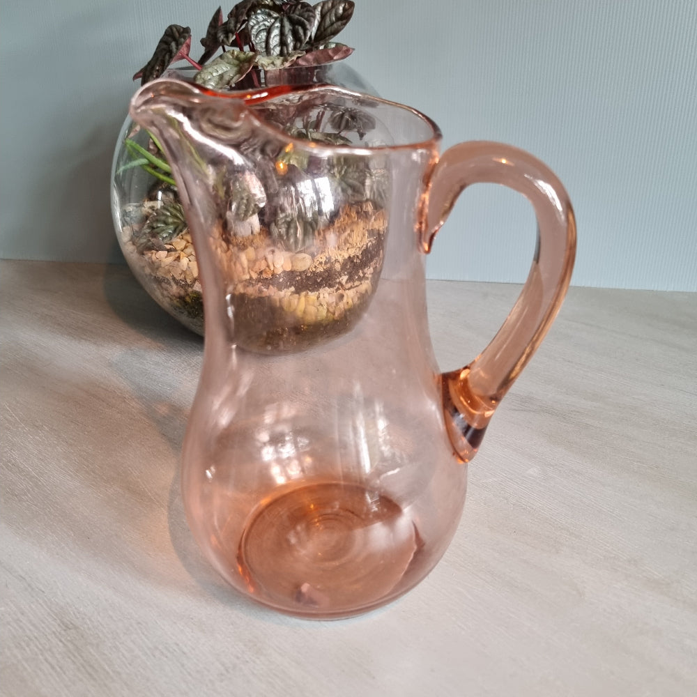 Vintage pink glass jug with curved handle and soft blush tint.