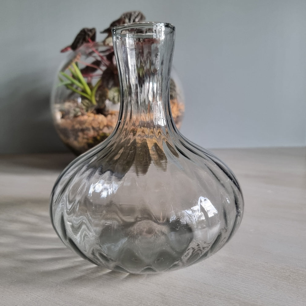 Vintage clear optic glass vase with swirl pattern and fluted neck.