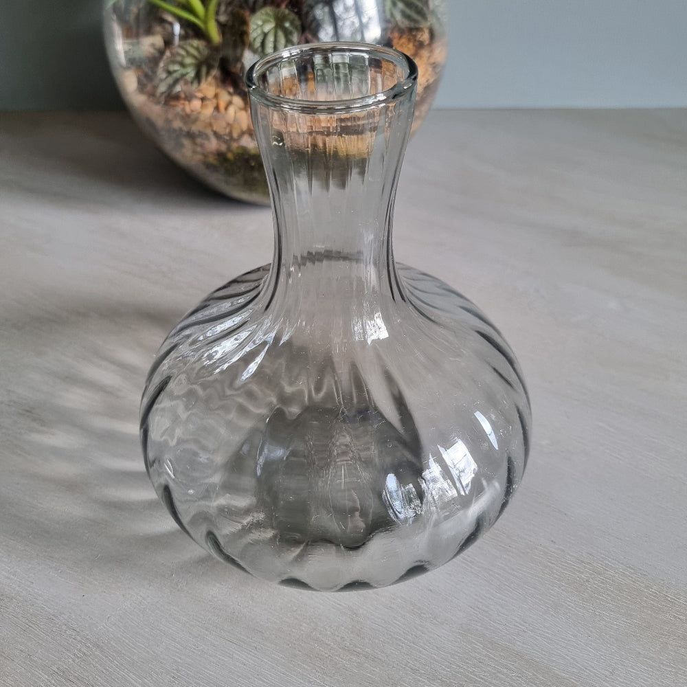 Vintage clear optic glass vase with swirl pattern and fluted neck.