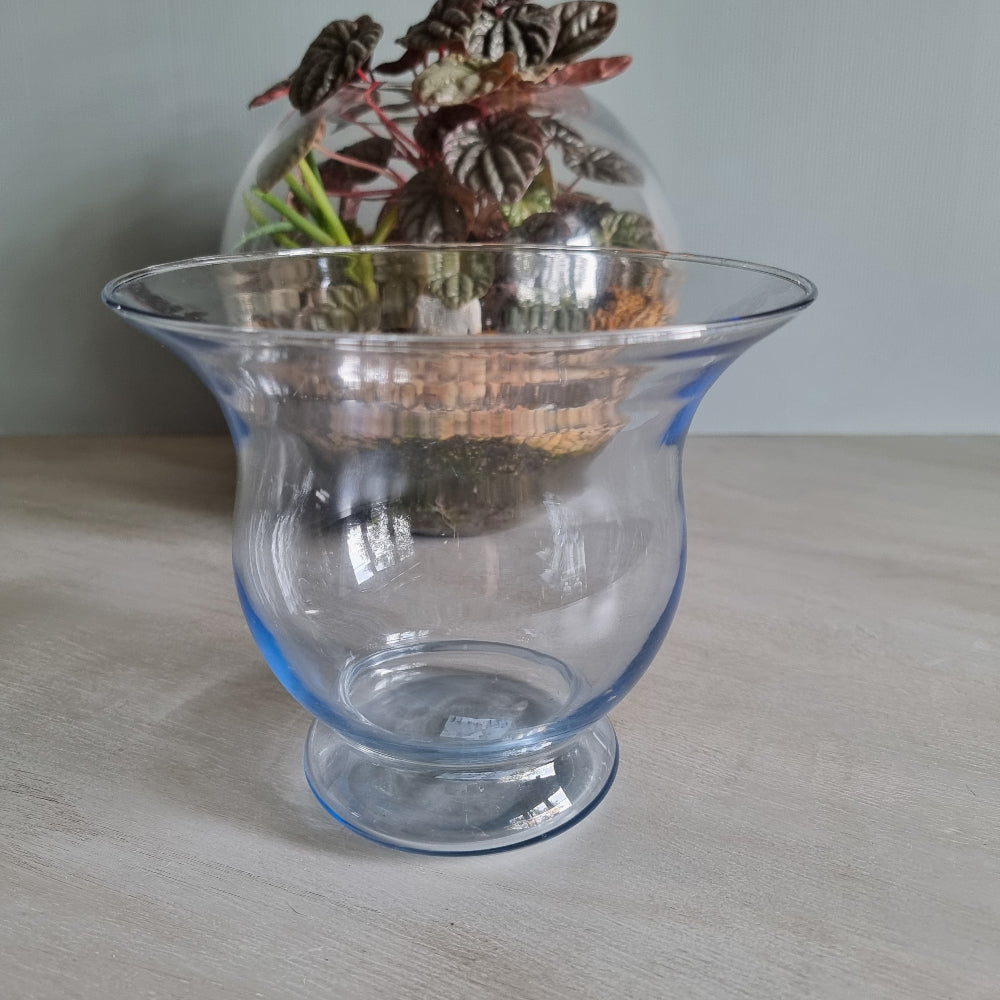 Vintage blue glass vase with flared rim and soft blue tint.