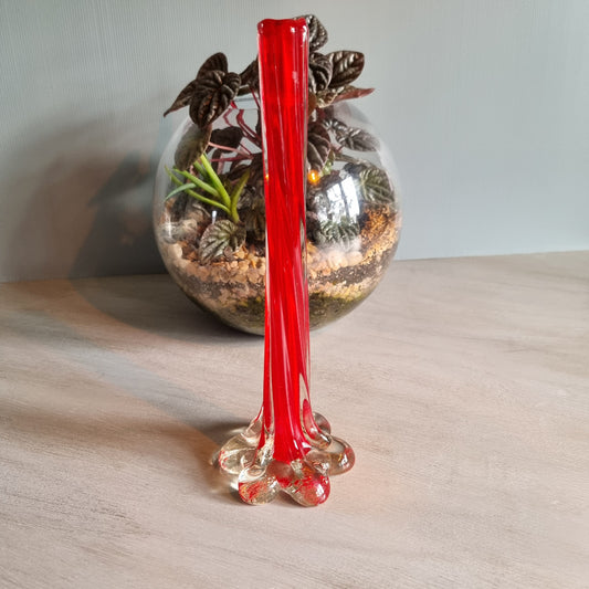 Vintage red art glass bud vase with clear base and pulled-stem design.