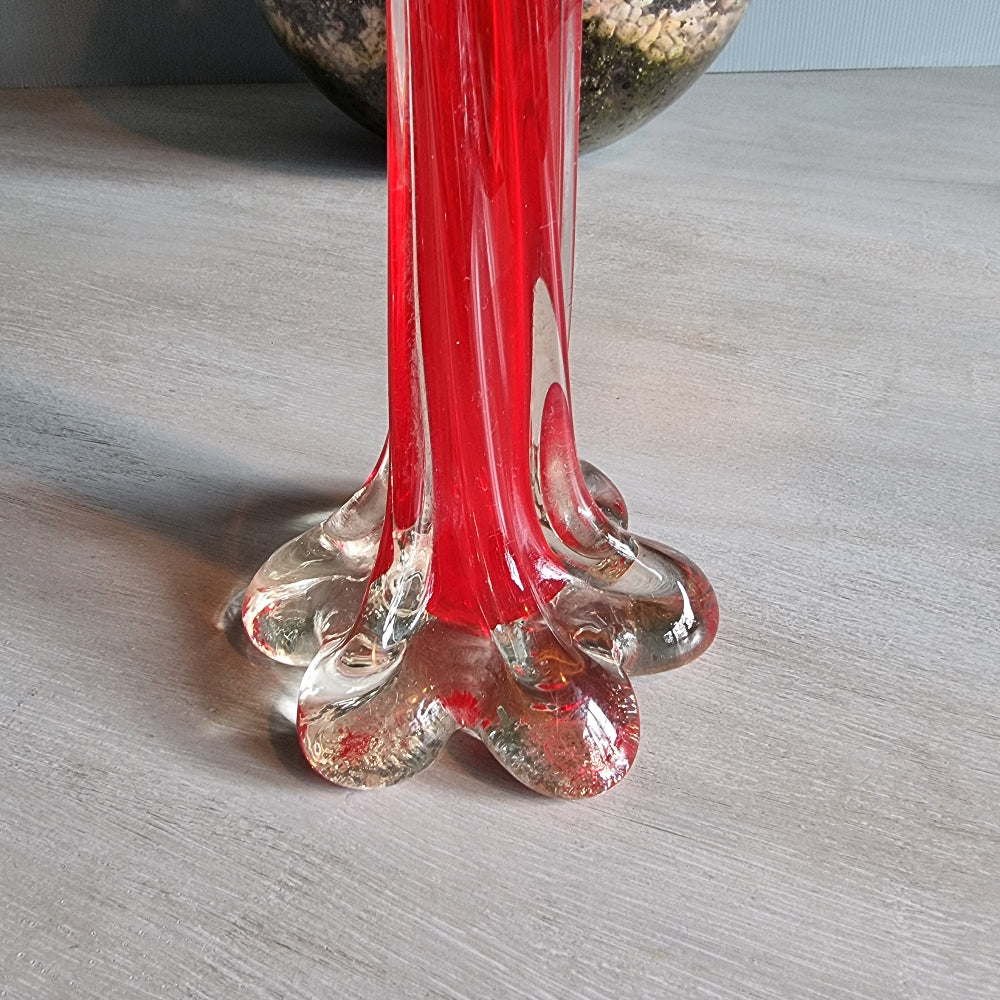 Vintage red art glass bud vase with clear base and pulled-stem design.
