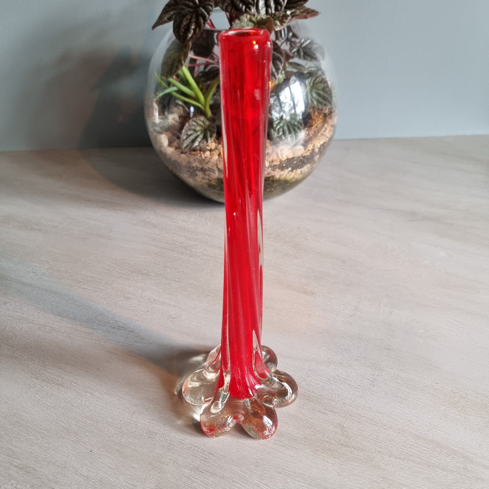 Vintage red art glass bud vase with clear base and pulled-stem design.