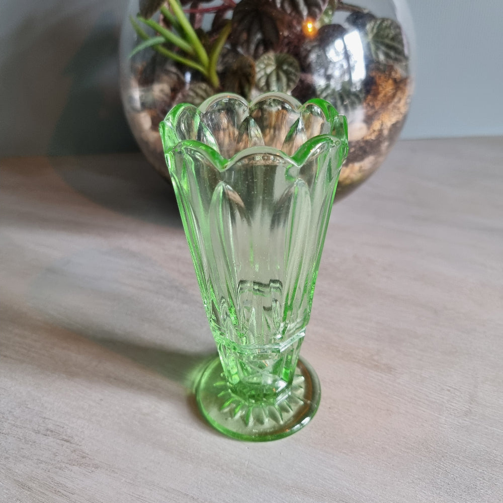 Vintage green Depression glass vase with scalloped rim.