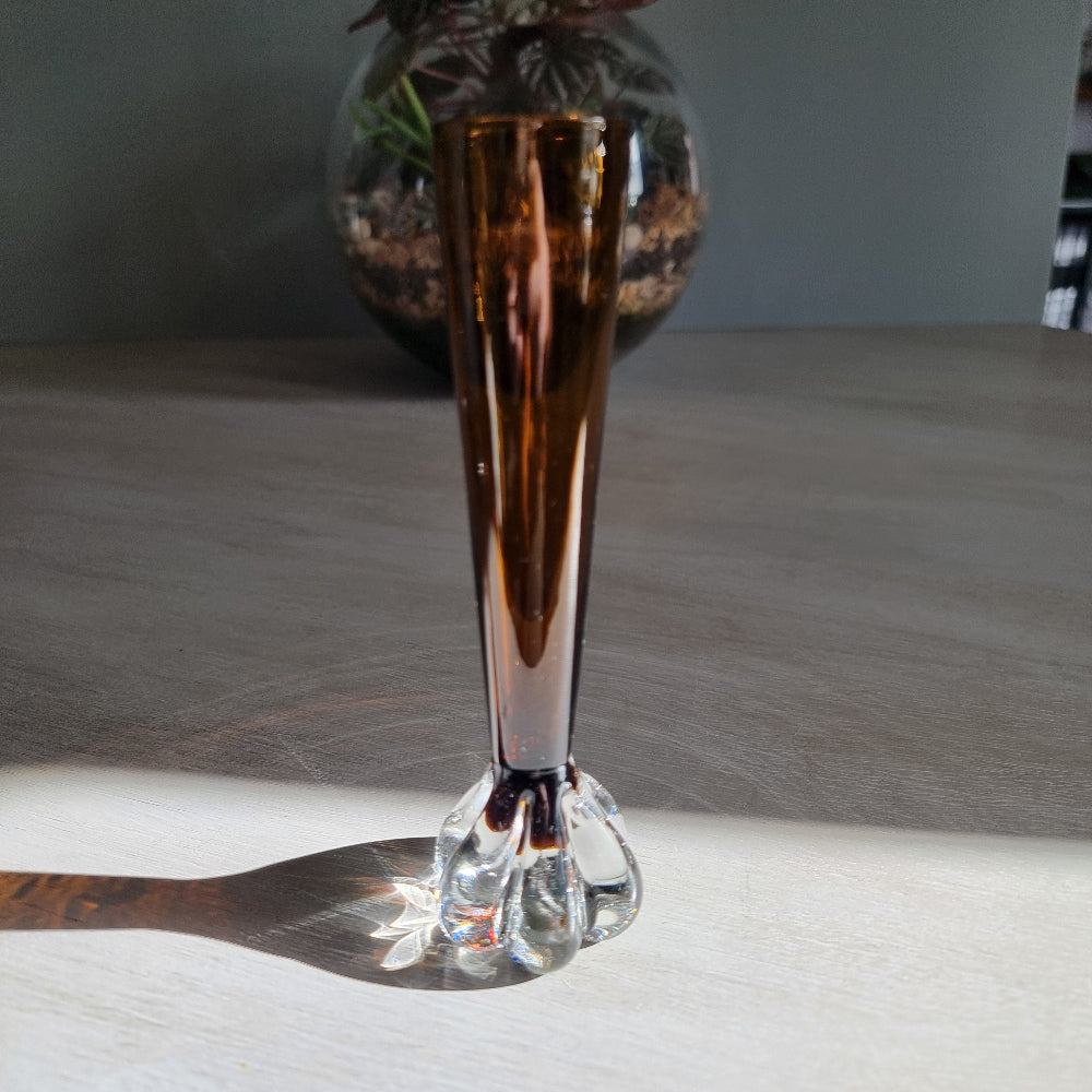 Vintage amber art glass bud vase with clear pulled base and warm retro glow.