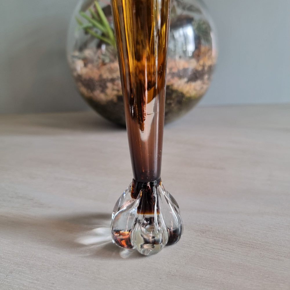 Vintage amber art glass bud vase with clear pulled base and warm retro glow.