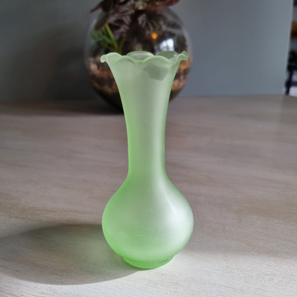 Vintage frosted green glass bud vase with ruffled rim and matte finish.