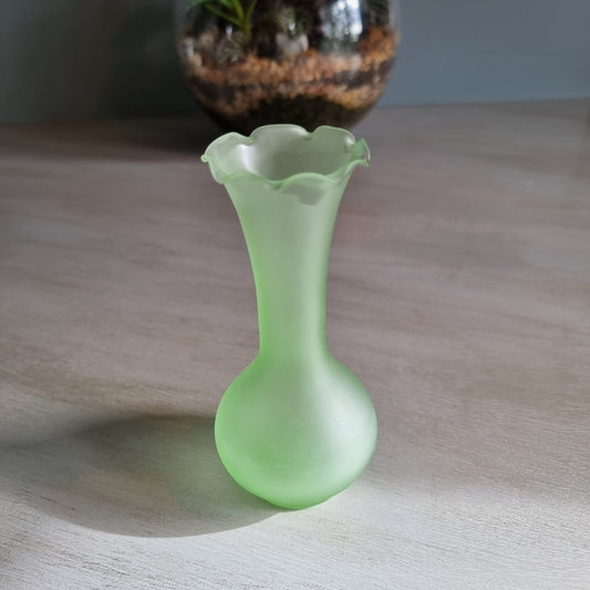 Vintage frosted green glass bud vase with ruffled rim and matte finish.